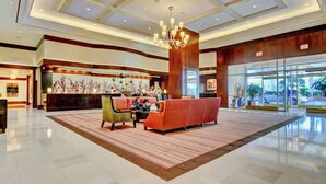 A spacious lobby with a reception desk, seating area, and a large window offering a view of the outside. - Strip View MGM Signature  Studio ★ No resort fees (Las Vegas)