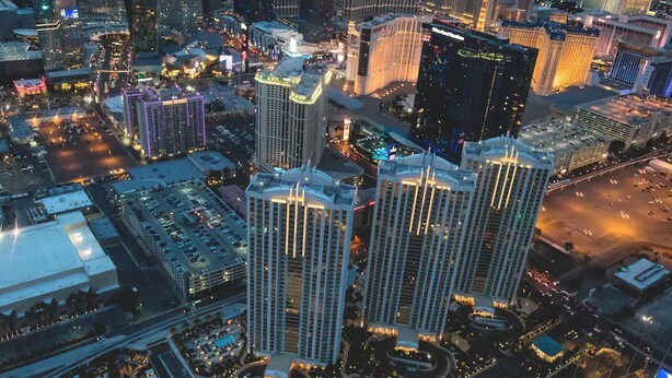 A high-rise hotel with multiple floors, surrounded by other buildings and busy streets. - Strip View MGM Signature  Studio ★ No resort fees (Las Vegas)
