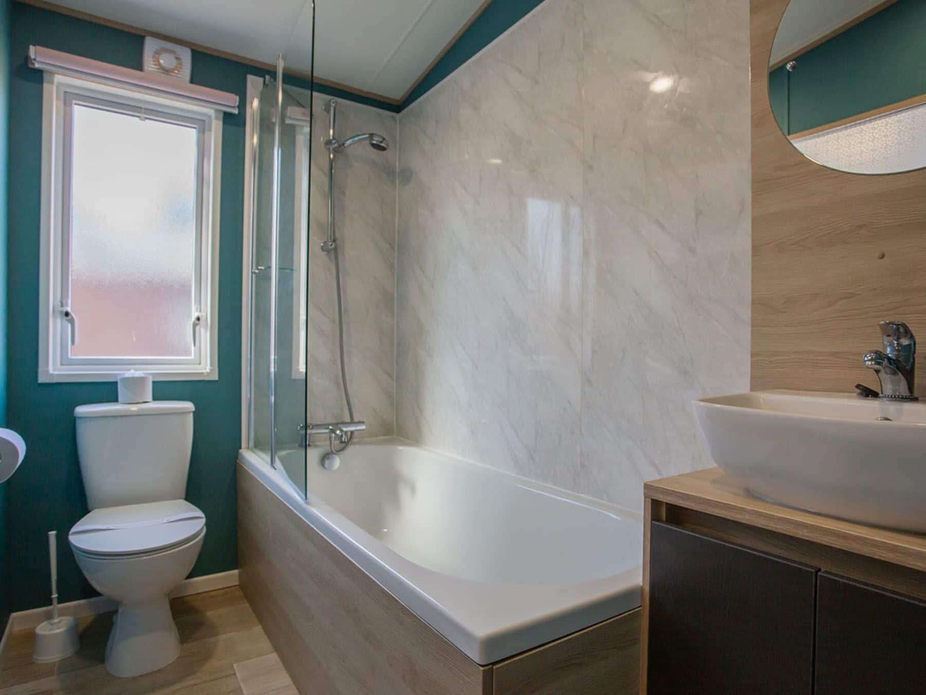 A bathroom with a toilet, a bathtub, and a sink.
