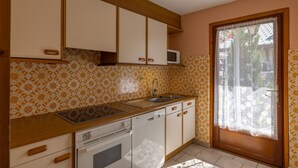 A kitchen with a microwave, sink, stove, and dishwasher. - Apartment 'La Rose des Vents N 1' with Mountain View, Balcony & Wi-Fi (Châtel)