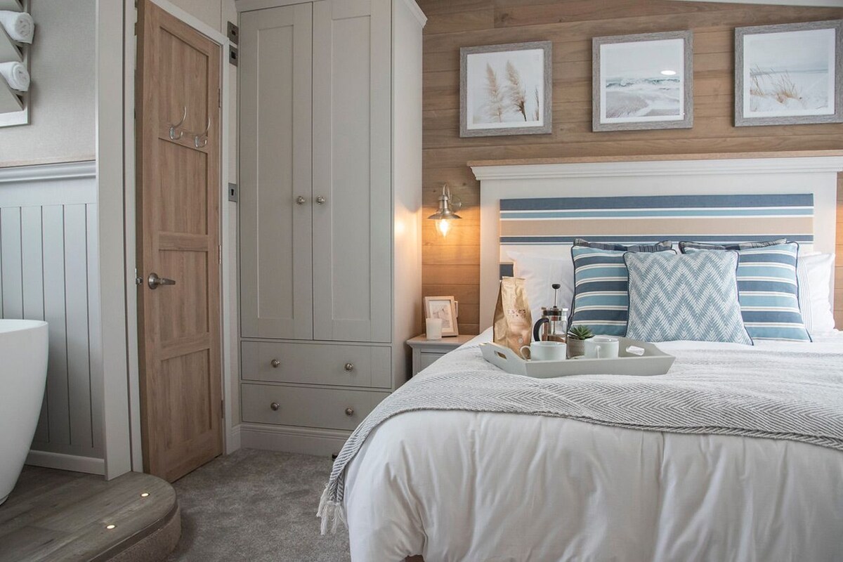 A bedroom with a bed, bedside table, and a wardrobe.