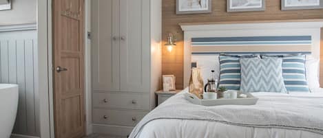 A bedroom with a bed, bedside table, and a wardrobe.