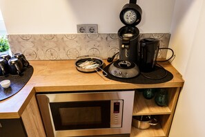 Kjøleskap, mikrobølgeovn, vannkoker og høy barnestol