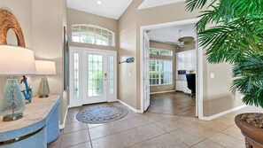 Enter a serene space with a ceiling fan and a window with blinds, surrounded by a potted plant.