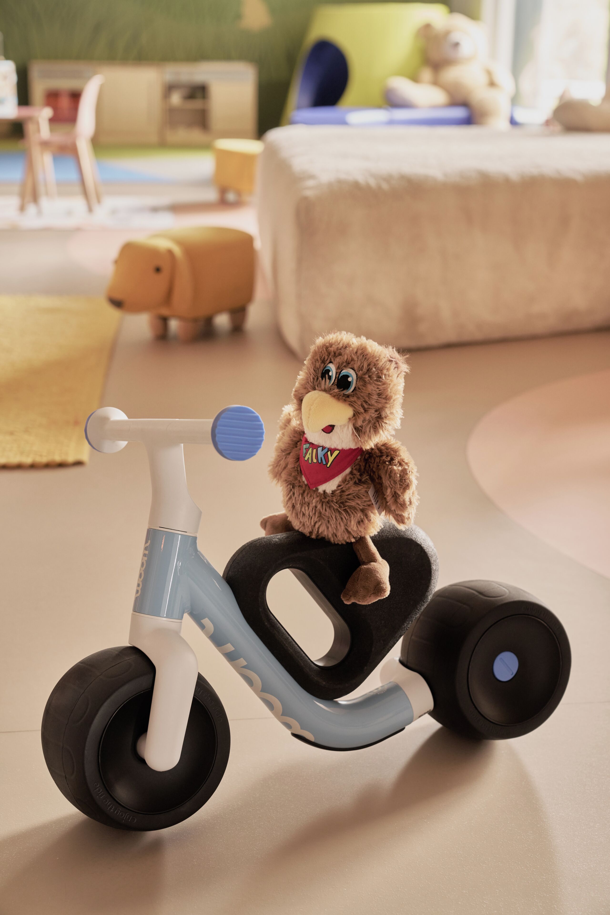 A toy with a bear-like figure on a tricycle.