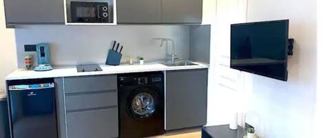 Fridge, microwave, coffee/tea maker, cookware/dishes/utensils