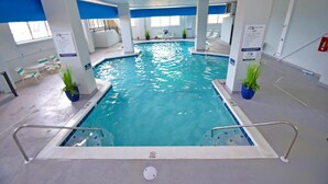 An indoor swimming pool with clear water, surrounded by white pillars, and a blue ceiling. - Marigot Beach 303 2 Bedroom Condo by RedAwning (Ocean City)