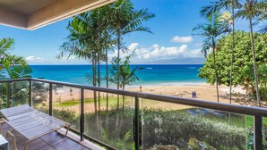 A balcony with a view of a beach and ocean. - Sands Of Kahana 315 2bd/2ba Oceanfront 2 Bedroom Condo by RedAwning (Lahaina)