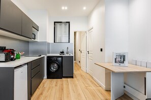 Fridge, microwave, coffee/tea maker, cookware/dishes/utensils