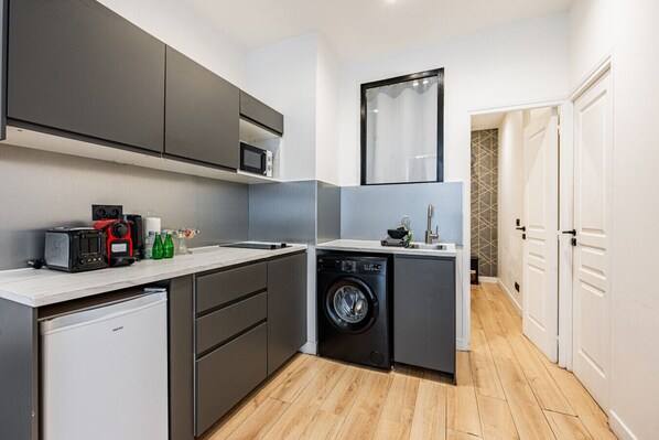 Fridge, microwave, coffee/tea maker, cookware/dishes/utensils