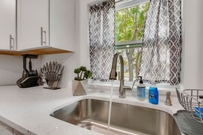 Enjoy cooking in this well-equipped kitchen with a stainless steel sink and ample counter space.