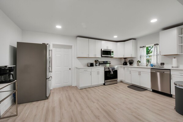 Enjoy cooking in this well-equipped kitchen with a microwave, oven, and dishwasher.