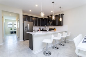 Enjoy dining or socializing at the kitchen island with bar stools.