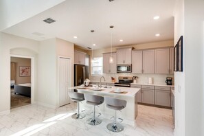 Enjoy cooking and dining in this well-equipped kitchen with a central island and dining area.