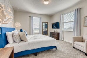 A bedroom with a large bed, a dresser, a chair, and a television. - Last Minute Disney! Private Pool, Hot Tub & Themed Bedrooms. Book Now! #43337 (Orlando)