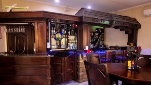 A bar area with wooden furnishings, a stone counter, and a menu board. - Crown Hotel Piarco (Piarco)