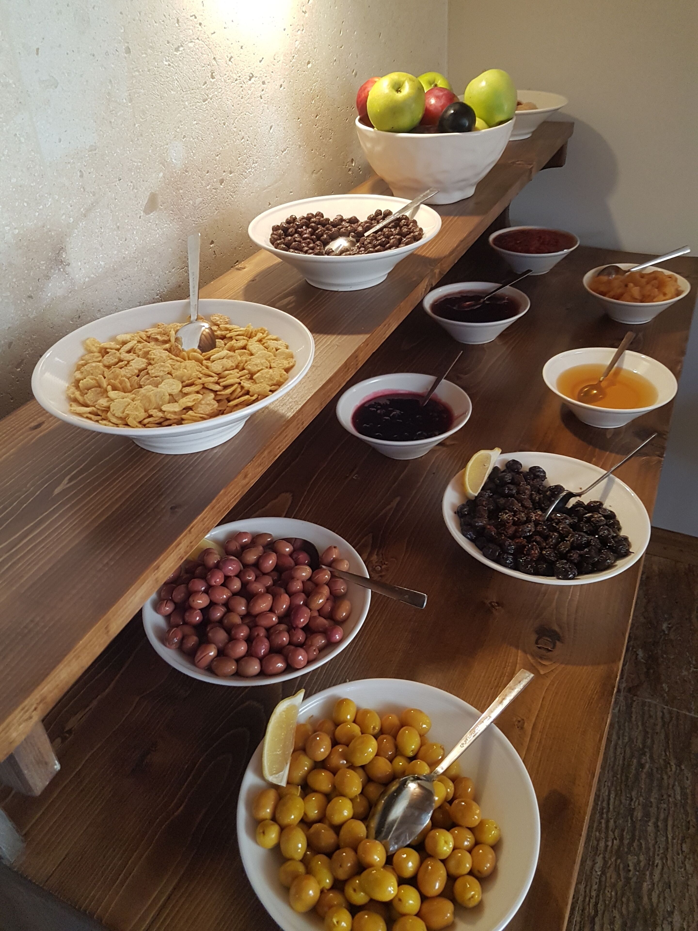 A table with various bowls containing different foods and fruits.
