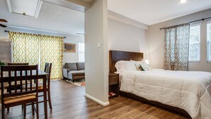 A bedroom with a bed, a nightstand, a chair, and a dining table. - prof cleaned*Peaceful & Close 2 Dwntwn (Dallas)