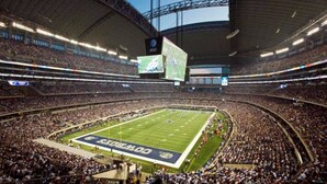 A large indoor stadium with multiple tiers of seating, a central field, and a scoreboard. - Month Discount!Quiet Studio Apartment*Walk to UTA* (Arlington)