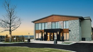 A modern building with a stone facade, large windows, and a flat roof. - Mount Alverno Luxury Resorts (Caledon)