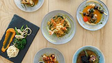 A variety of dishes on a wooden table.