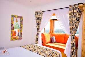 Relax in this inviting room with a large bed, sofa, and stunning view.