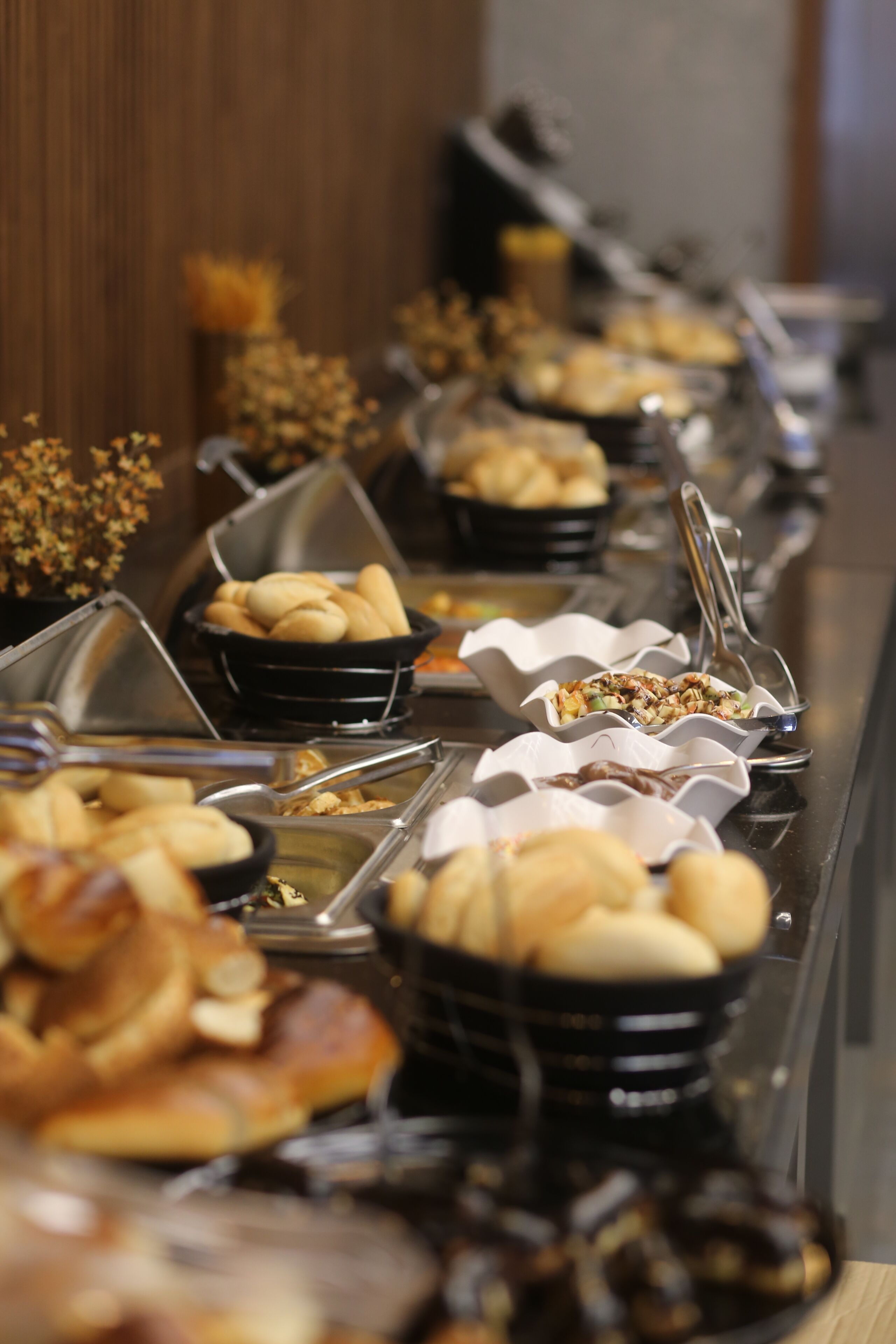 A buffet with various food items in bowls and containers.