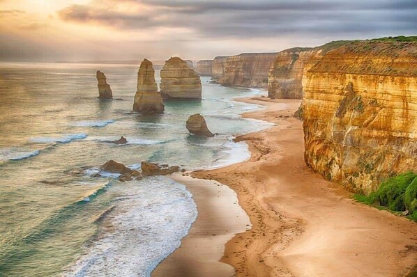 Experience the Twelve Apostles, a stunning natural sandstone formation along the Port Campbell National Park coastline in Victoria, Australia.