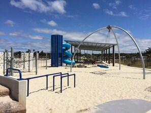 Kids can play on the spiral slide and enjoy the covered seating area.