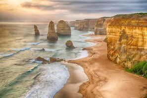 A coastal landscape with cliffs and a beach.
