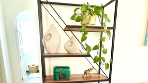 A black metal shelving unit with three shelves, each holding various decorative items. - Beautiful apartment in downtown Polanco (Ciudad de México)
