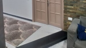 A room with a wooden ceiling, a door labeled '501', a patterned rug, and a stone wall. - Gardenia Hotel (Cairo)