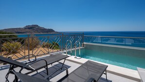 A pool area with lounge chairs and a view of the ocean. - Sunset view villa in plakias,sea view,Private pool (Plakias)