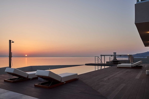 A heated pool, pool loungers