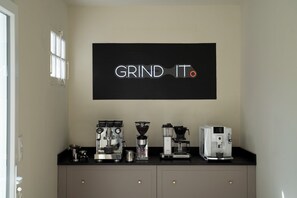 A coffee station with multiple espresso machines and a large sign that reads "GRIND IT". - Luxury Pyrenees Villa, Tourmalet, gardens, gym - 7 bedrooms (Adast)