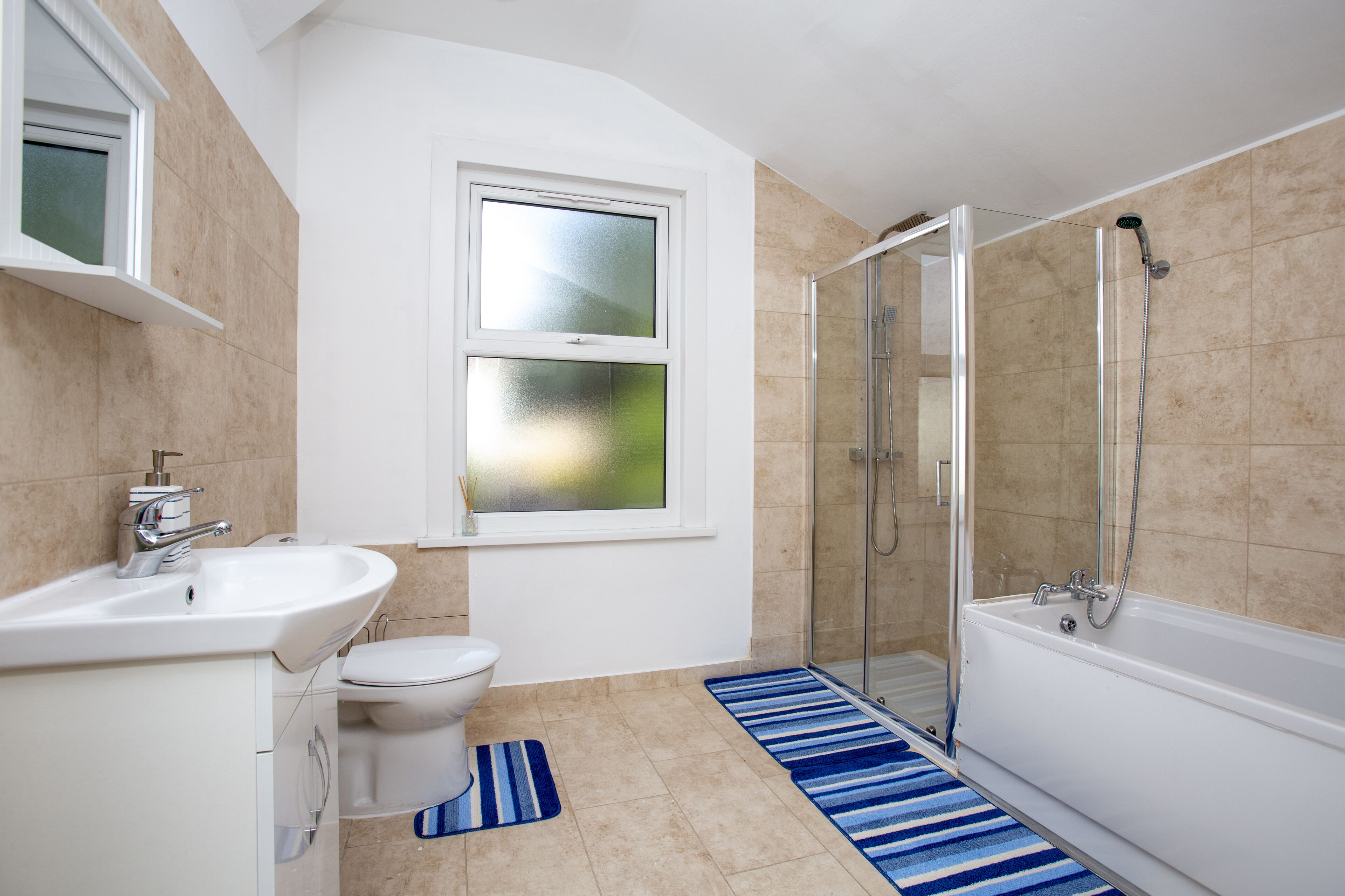 Bathtub, towels, soap, toilet paper