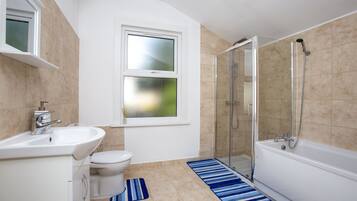 Bathtub, towels, soap, toilet paper
