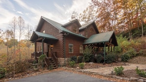 A rustic log cabin with a porch and a covered outdoor seating area. - Pet-Friendly Blue Ridge Cabin on 9 Acres! Views, Theater, Game Room, Trails! (Blue Ridge)