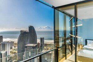 A high-rise hotel room with a panoramic ocean view, featuring modern architecture and a glass balcony. - The Darling of Broadbeach - with spectacular views (Broadbeach)