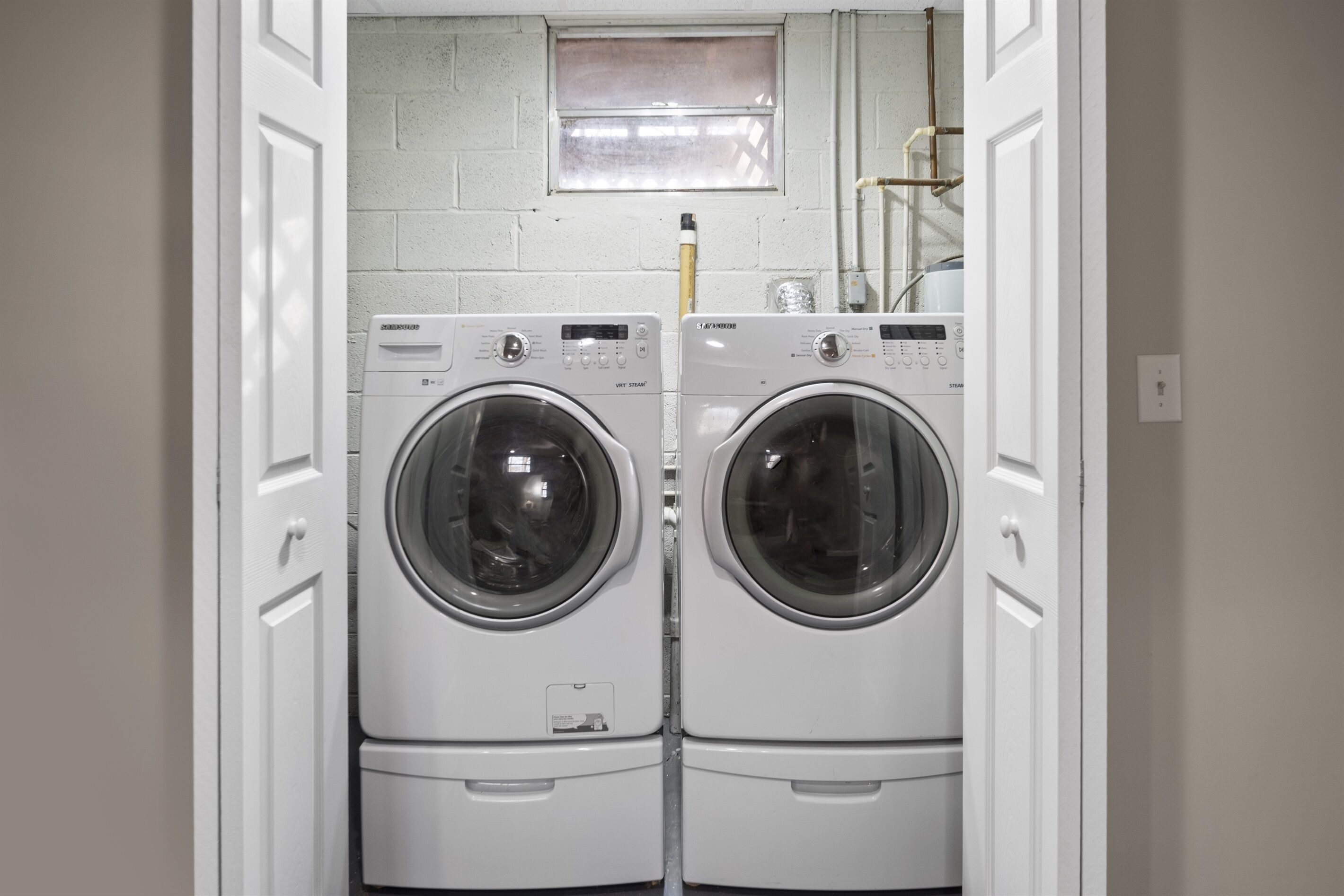 A laundry room with two front-loading washing machines.