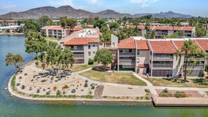 A resort with multiple buildings, a landscaped area with a pool, and mountains in the background. - Lakefront Family, 3 Bedroom, 2 Bath, Private Patio, Heated Pool, Jacuzzi  (Phoenix)