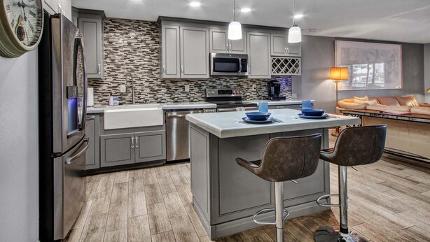 A modern kitchen with a central island, stainless steel appliances, and pendant lighting. - Lakefront Family, 3 Bedroom, 2 Bath, Private Patio, Heated Pool, Jacuzzi  (Phoenix)