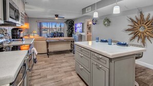 A modern kitchen with a central island, built-in appliances, and pendant lighting. - Lakefront Family, 3 Bedroom, 2 Bath, Private Patio, Heated Pool, Jacuzzi  (Phoenix)