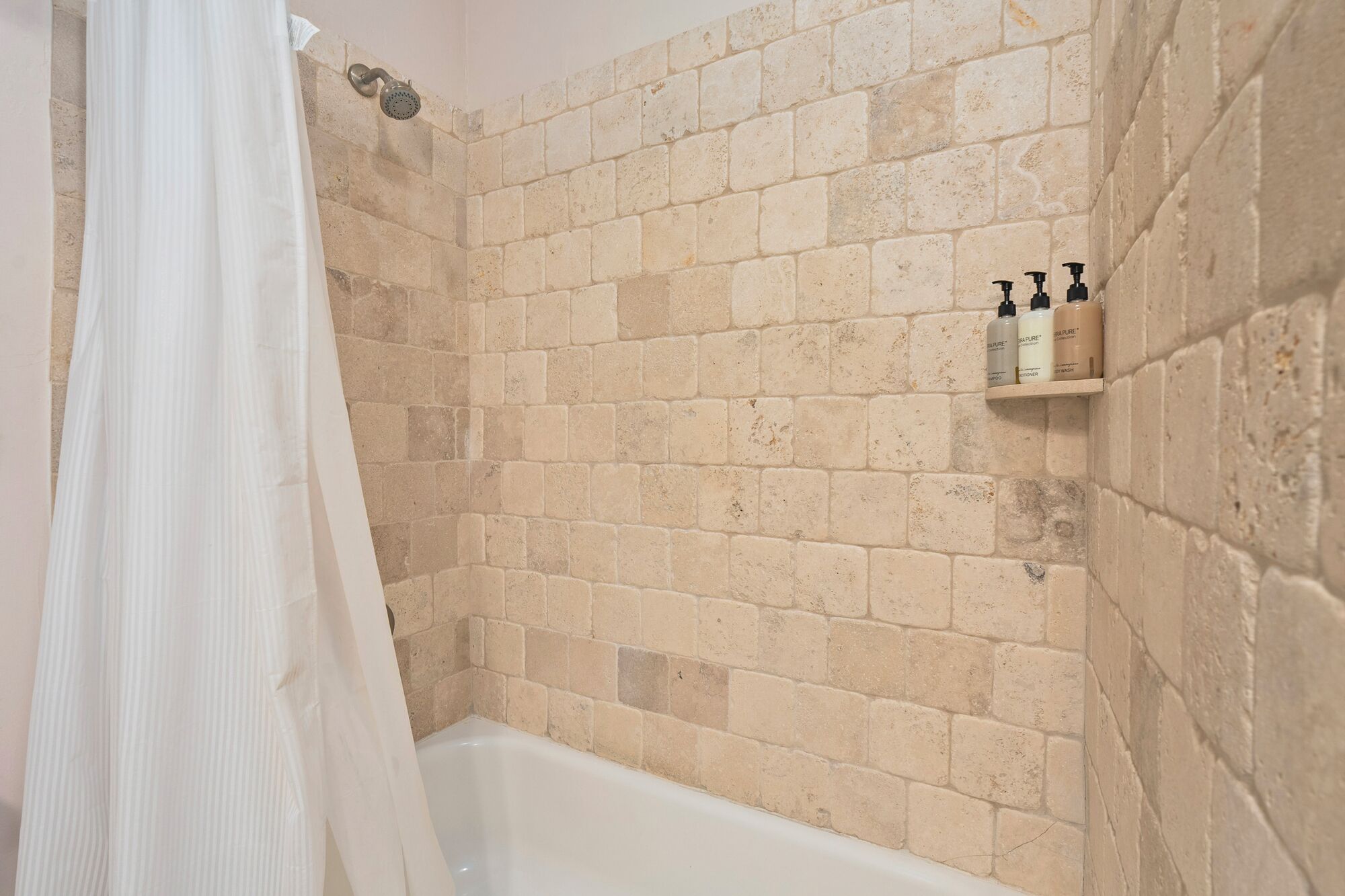 Combined shower/tub, hair dryer, soap, shampoo