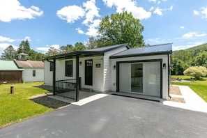 Situated in a peaceful, landscaped area, this single-story home offers a covered porch and attached garage.