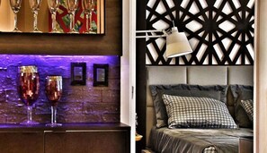 Experience a stylish retreat with a geometric-patterned wall, a tufted headboard, and a pendant lamp.