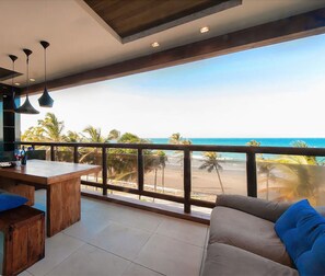 Enjoy ocean views from the large window or balcony in this spacious living space.