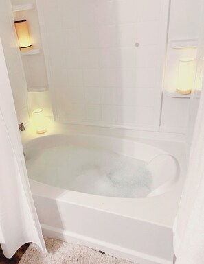 Combined shower/bathtub, towels, soap, toilet paper