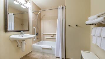 A bathroom with a sink, mirror, shower, and bathtub.