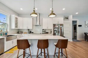 Enjoy cooking in this well-equipped kitchen with a large island and stainless steel appliances.